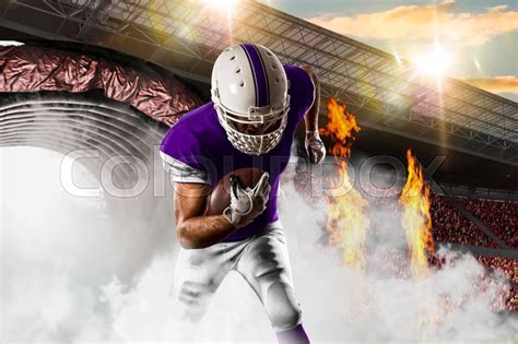 Football Player with a purple uniform ... | Stock image | Colourbox