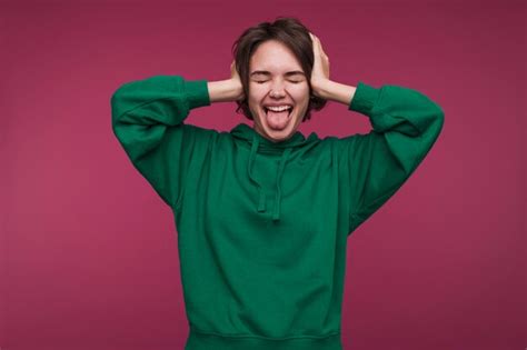 Free Photo | Front view of a young woman covering her ears and being silly