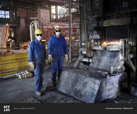 Industry- Smeltery: Workers in front of blast furnace with helmet and ...