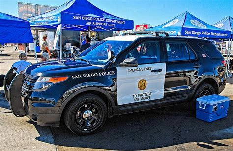 a san diego police car parked in front of tents