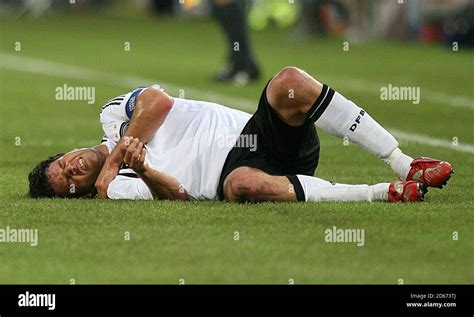 Germany's Michael Ballack lies injured following a challenge Stock ...