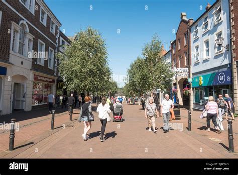 People walking along the pedestrianised Scotch Street in Carlisle city centre, Cumbria, England ...