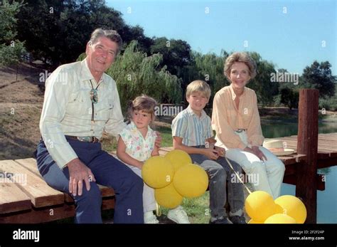 President Ronald Reagan and Nancy Reagan sitting on the dock with their ...