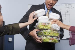 Businessman hoarding food Royalty-Free Stock Image - Storyblocks