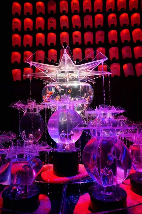 an array of clear plastic objects sitting on top of a table in front of red and blue lights