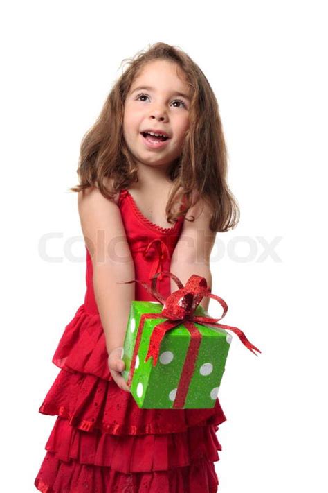 Young happy child holding a present with gleeful smile | Stock Photo | Colourbox