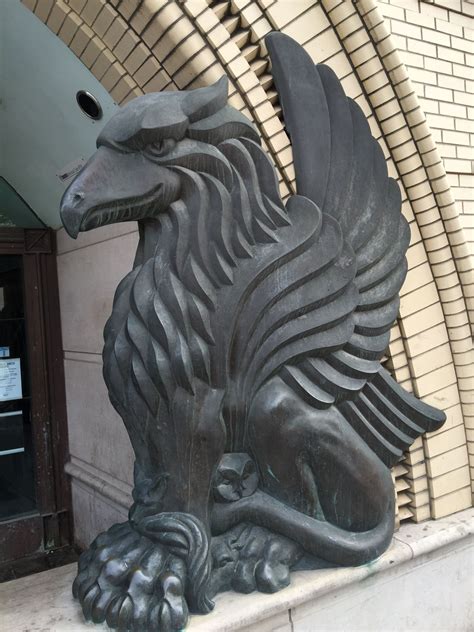 a statue of a dragon on the outside of a building