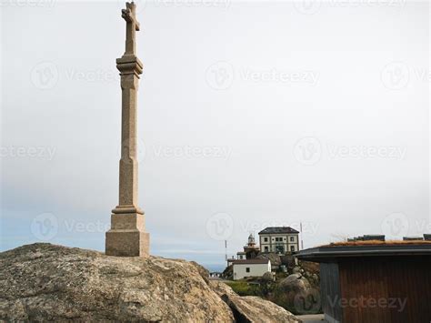 cross and view of lighthouse on Cape Finisterre 11849185 Stock Photo at ...