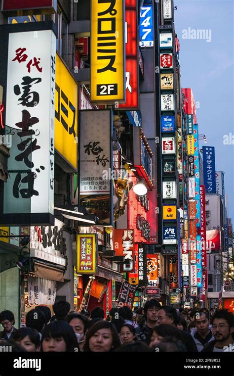 Colourful neon signs on buildings in Shinjuku early evening, Tokyo ...