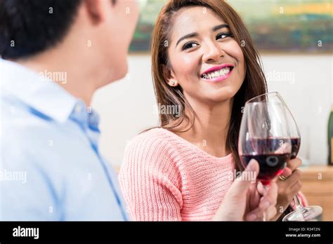 Couple toasting the red wine glasses Stock Photo - Alamy