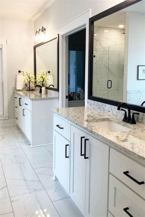 a large bathroom with two sinks and mirrors on the wall, along with ...