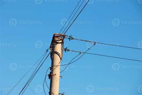 Electric pole with a linear wire against the blue sky close-up. Power electric pole. 19764229 ...