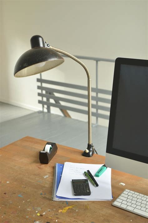 Computer and lamp on office desk with papers · Free Stock Photo