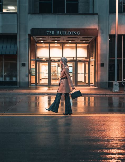 Woman in Black Coat Walking on Sidewalk · Free Stock Photo