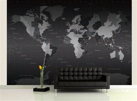 a living room with a black couch and a large map on the wall behind it