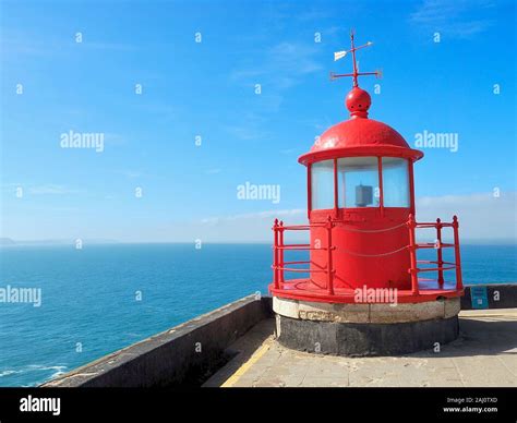 Famous lighthouse in Nazare in Portugal surrounded by Atlantic ocean Stock Photo - Alamy