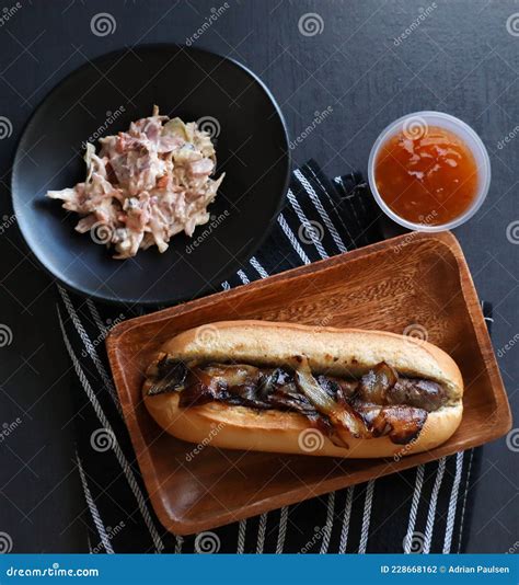 Boerewors Roll With Braised Onions Coleslaw And Sweet Chilli Sauce ...