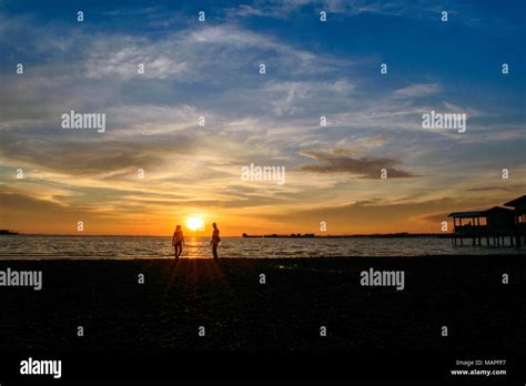 silhouette couple in the beach against sunset - Bintan island ...