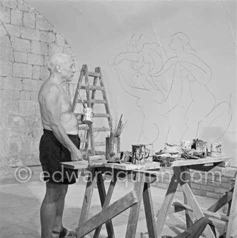 Pablo Picasso working on the "War and Peace study" drawings on the wall ...