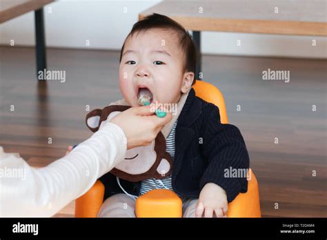 Korean baby eating baby food Stock Photo - Alamy