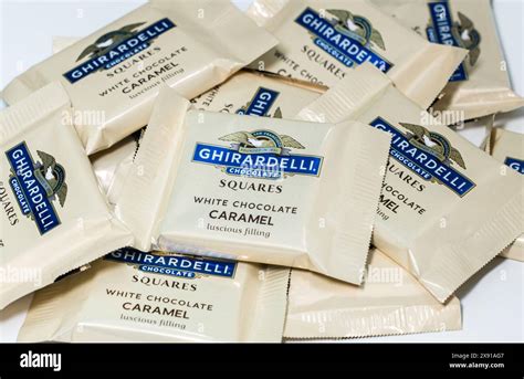 A pile of Ghirardelli White Chocolate Caramel Squares Stock Photo - Alamy