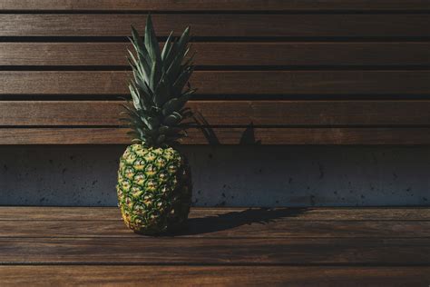 Green Pineapple on Brown Wooden Bench \ · Free Stock Photo