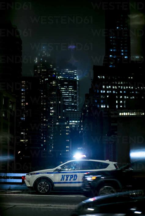 USA, New York, New York City, NYPD night patrol car with emergency ...