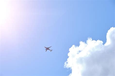 Premium Photo | Plane takes gainst background blue sky and white clouds