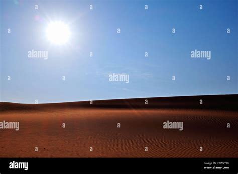 Bright blue morning sky and rippled desert sand in Al Dahna Desert ...