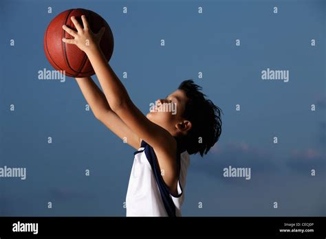 Young boy catching basket ball Stock Photo - Alamy