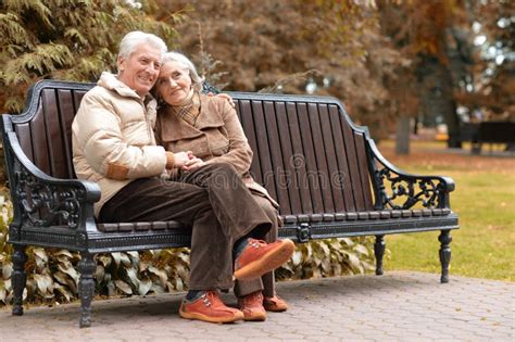 Happy Elderly Couple Sitting on a Bench in Autumn Park Stock Image - Image of relationship ...