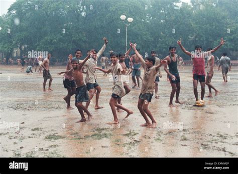 Children playing football in monsoon rain Azad Maidan Mumbai India ...