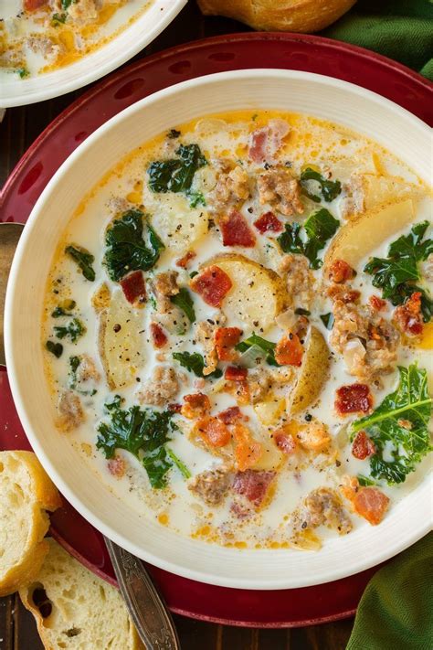 Zuppa Toscana soup in a white single serve bowl set over a red plate. | Zuppa toscana soup olive ...