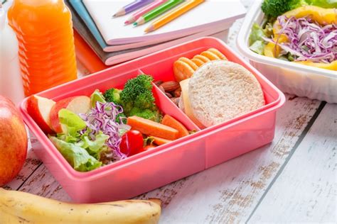 Premium Photo | Healthy lunch box set of sandwich cheese with cracker and salad in box, banana ...