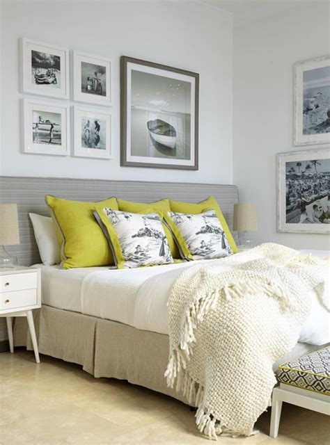 An all white bedroom with yellow accents featuring two gallery style ...