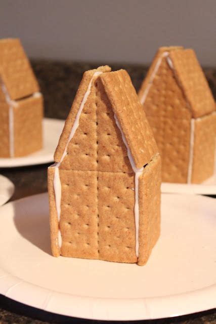 graham cracker gingerbread houses put together with icing | Graham cracker gingerbread house ...