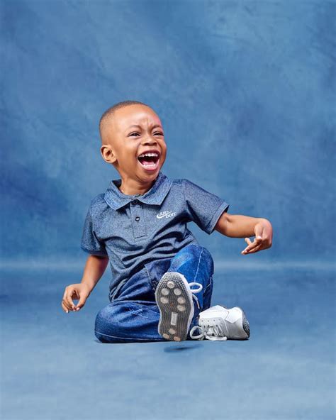 Laughing Boy on Blue Background · Free Stock Photo