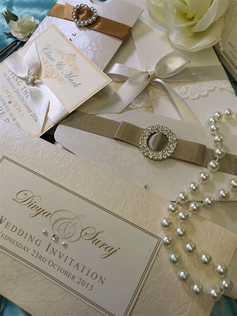 the wedding stationery is laid out on top of each other with pearls and ...