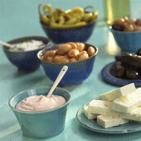 Greek starters, feta cheese, taramas, tsatsiki and pickled vegetables stock photo