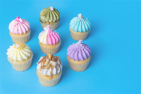 Premium Photo | Colorful mini cupcake on blue background copy space