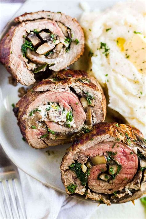 This oven baked stuffed flank steak with mushroom and spinach is rolled and cooked to perfection ...