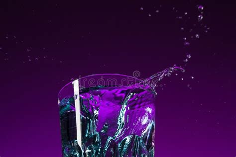 The Water Splashing in Glass on Lilac Background Stock Photo - Image of bright, bulb: 112276508