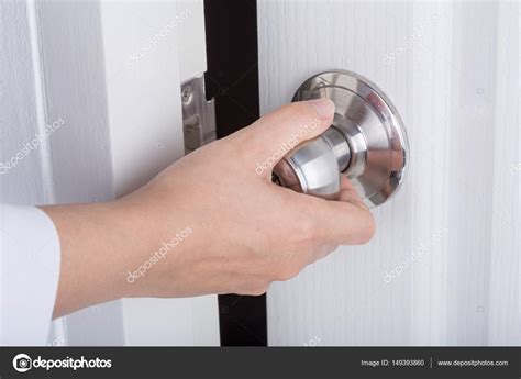 Hand opening door knob on white door Stock Photo by ©geargodz 149393860