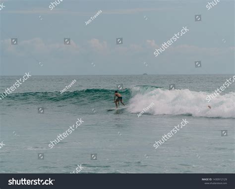 Montanita, Ecuador - Feb 2019: Surfers surfing the waves on beautiful ...