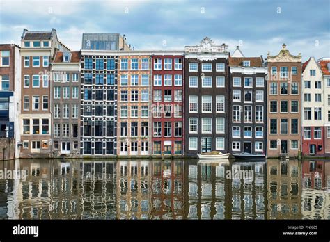 Amsterdam canal Damrak with houses, Netherlands Stock Photo - Alamy