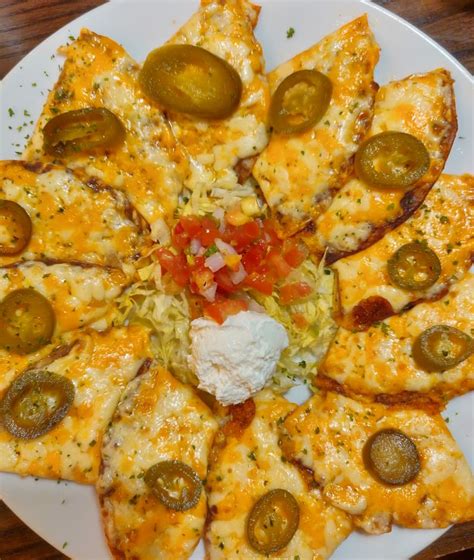 Nachos with melted cheese and jalapeno ! An amazing dish for starter ...