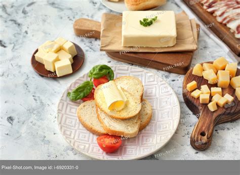 Slices of bread with fresh butter and cheese on white background :: Stock Photography Agency ...