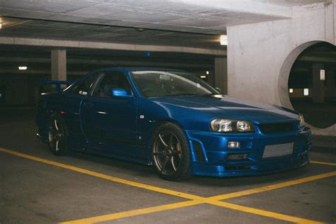 A Blue Nissan Skyline GT-R Parked in a Parking Lot · Free Stock Photo