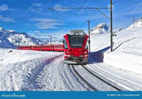 A Red Swiss Train Running Through The Snow Stock Photo - Image: 48601746