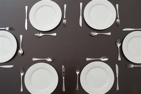 Table set with white plates and cutlery - Free Stock Image